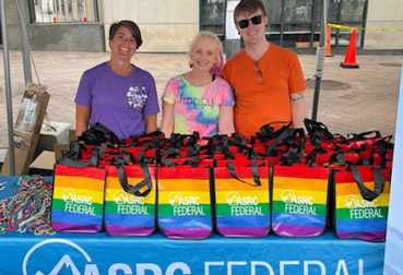 Employees at the ASRC Federal tent at the Pride Parade